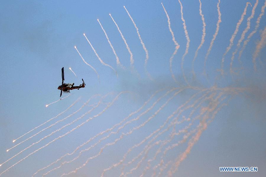 A U.S. helicopter fires during the Eager Lion military exercise, at the Quweira city, 290km south of Amman, Jordan, June, 19, 2013. The 12-day exercise involves combined air, land and sea maneuvers across Jordan. Along with Jordan and the U.S., the exercise brings together some 8,000 personnel from 19 Arab and European nations to train on border security, irregular warfare, anti-terrorism and counterinsurgency. (Xinhua/Mohammad Abu Ghosh)