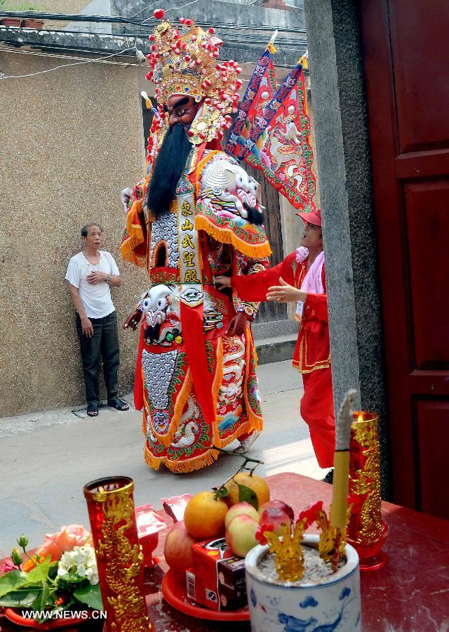 Locals participate in an annual parade honoring Guandi at Tongling Town in Dongshan County, southeast China's Fujian Province, June 20, 2013. Guandi, namely Guan Yu, was a senior general of shu han (221-263) during the three kingdoms period. Guan had been deified by feudal rulers of past ages because of his loyalty to his kingdom and was dubbed "guandi (emperor guan of military strategies)". Guan and confucius, known as the "emperor of education", were usually considered equal in status. (Xinhua/Wang Song) 