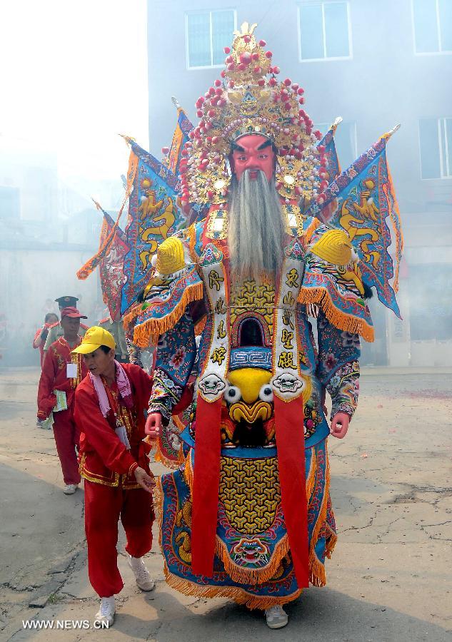 Locals participate in an annual parade honoring Guandi at Tongling Town in Dongshan County, southeast China's Fujian Province, June 20, 2013. Guandi, namely Guan Yu, was a senior general of shu han (221-263) during the three kingdoms period. Guan had been deified by feudal rulers of past ages because of his loyalty to his kingdom and was dubbed "guandi (emperor guan of military strategies)". Guan and confucius, known as the "emperor of education", were usually considered equal in status. (Xinhua/Wang Song) 