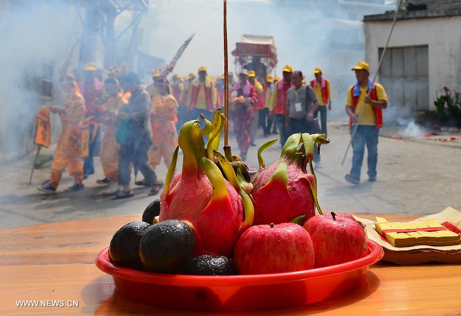 Locals participate in an annual parade honoring Guandi at Tongling Town in Dongshan County, southeast China's Fujian Province, June 20, 2013. Guandi, namely Guan Yu, was a senior general of shu han (221-263) during the three kingdoms period. Guan had been deified by feudal rulers of past ages because of his loyalty to his kingdom and was dubbed "guandi (emperor guan of military strategies)". Guan and confucius, known as the "emperor of education", were usually considered equal in status. (Xinhua/Wang Song) 