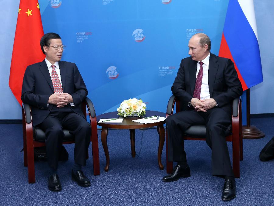 Russian President Vladimir Putin meets with Chinese Vice Premier Zhang Gaoli (L) who is the representative of Chinese government to attend the St. Petersburg International Economic Forum, in St. Petersburg, Russia, June 20, 2013. (Xinhua/Pang Xinglei)