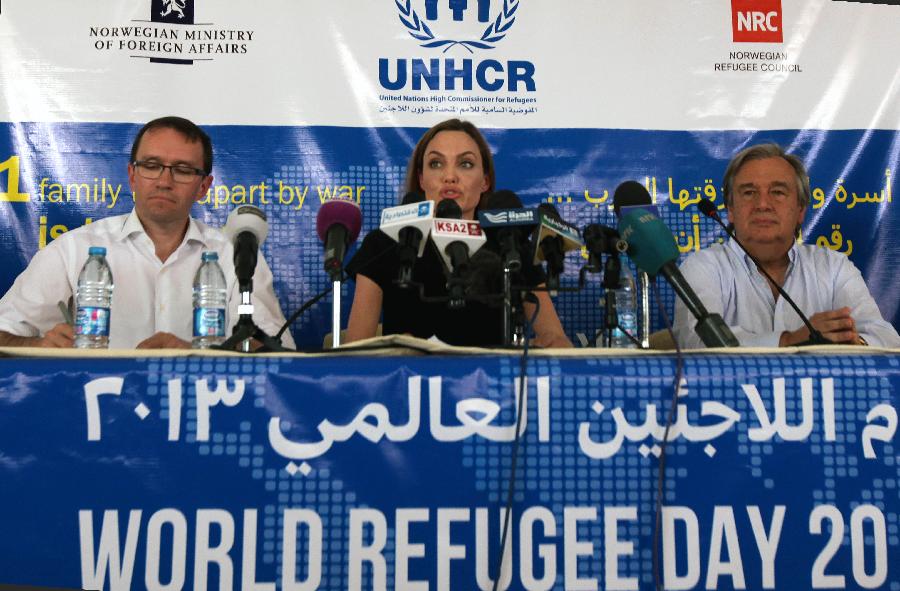 Actress Angelina Jolie (C) speaks to the media as the U.N. refugee agency's special envoy during a news conference with Norway's Foreign Minister Espen Barth Eide (L) and U.N. High Commissioner for Refugees (UNHCR) Antonio Guterres at the Al Zaatri refugee camp, in the Jordanian city of Mafraq, near the border with Syria, June 20, 2013, the World Refugee Day. The refugee camp is hosting Syrians displaced by the country's domestic conflict. (Xinhua/Mohammad Abu Ghosh) 