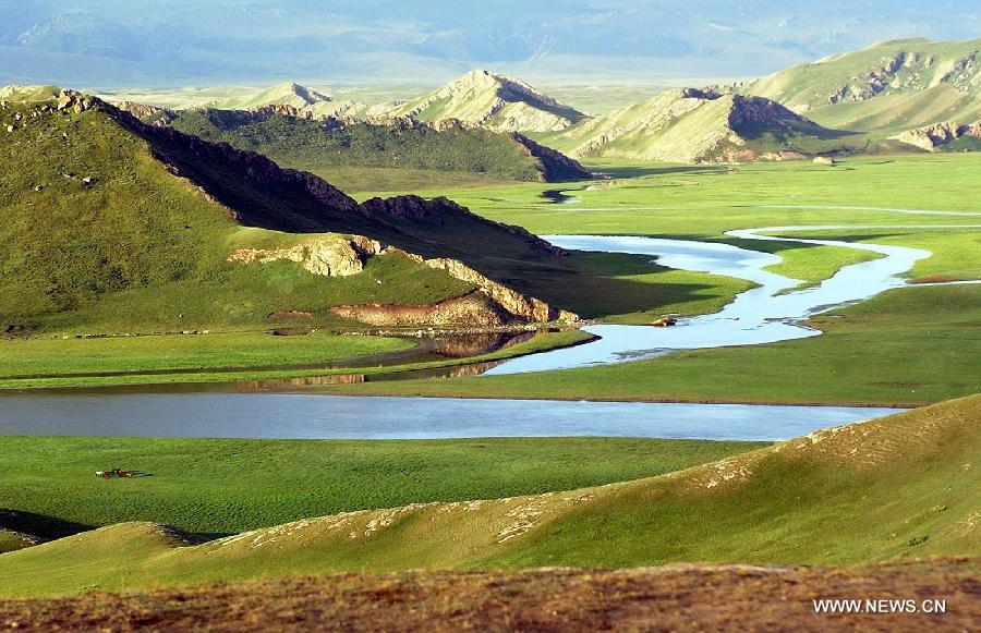 Photo taken on July 27, 2003 shows the scenery of Bayanbulak Grassland on the Tianshan in northwest China's Xinjiang Uygur Autonomous Region. The 37th session of UNESCO's World Heritage Committee (WHC) inscribed China's Xinjiang Tianshan on the World Heritage List as a natural site on June 21, 2013. Xinjiang Tianshan is a serial property totaling 606,833 hectares and consisting of four components which are located along the 1,760 km Tianshan range, a temperate arid zone surrounded by Central Asian deserts.(Xinhua/Luo Xiaoguang)