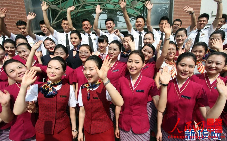 Wearing the uniforms of different airlines, graduates pose for photo on campus on June 19, 2013. (Xinhua/Liu Yuedong)