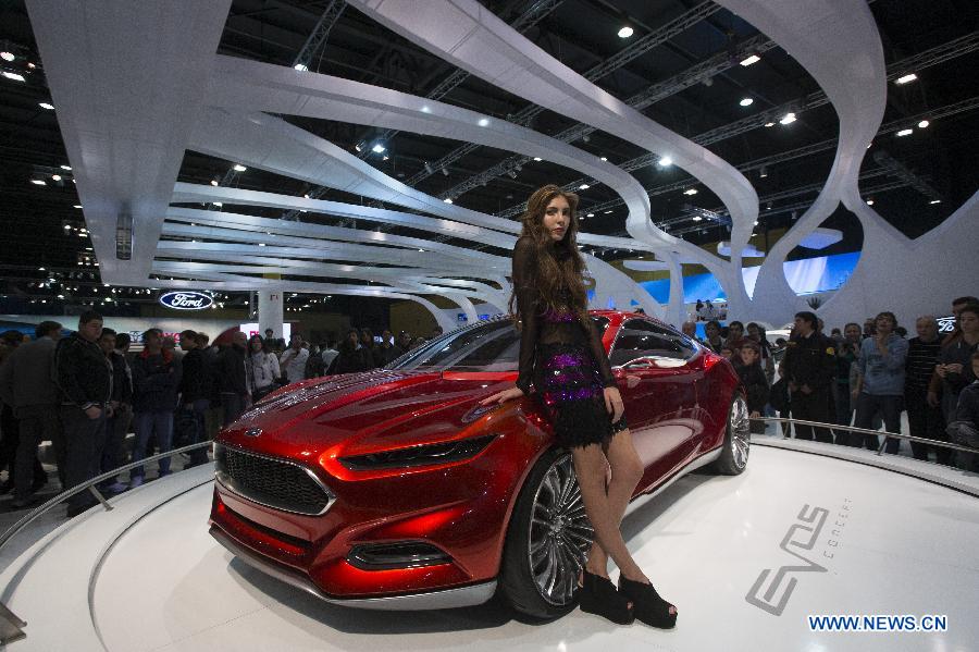 A model poses in front of Ford's Evos concept car during the 6th International Auto Show, in the city of Buenos Aires, capital of Argentina, on June 21, 2013. (Xinhua/Martin Zabala)