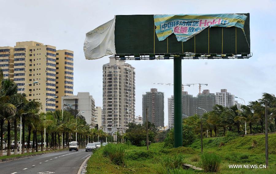 An advertisement board is damaged by strong wind near the Binjiang Road in Haikou City, capital of south China's Hainan Province, June 22, 2013. Tropical storm "Bebinca" is estimated to arrive in south China's Guangdong Province on Saturday afternoon, the first to make landfall in China this year, the National Meteorological Center (NMC) said on Saturday. Affected by the tropical storm, coastal areas in Hainan and Guangdong provinces were battered by gales and torrential rain, the center reported. (Xinhua/Guo Cheng)