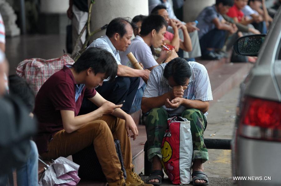 Passengers wait for the boat at Xiuying harbour in Haikou, capital of south China's Hainan Province, Jun 22, 2013. Tropical storm "Bebinca" is estimated to arrive in south China's Guangdong Province on Saturday afternoon, the first to make landfall in China this year, the National Meteorological Center (NMC) said on Saturday. Affected by the tropical storm, coastal areas in Hainan and Guangdong provinces were battered by gales and torrential rain, the center reported. (Xinhua/Zhao Yingquan) 