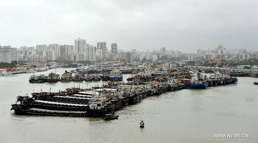 Ships berth in a harbor in Haikou City, capital of south China's Hainan Province, June 22, 2013. Tropical storm "Bebinca" is estimated to arrive in south China's Guangdong Province on Saturday afternoon, the first to make landfall in China this year, the National Meteorological Center (NMC) said on Saturday. Affected by the tropical storm, coastal areas in Hainan and Guangdong provinces were battered by gales and torrential rain, the center reported. (Xinhua/Guo Cheng) 