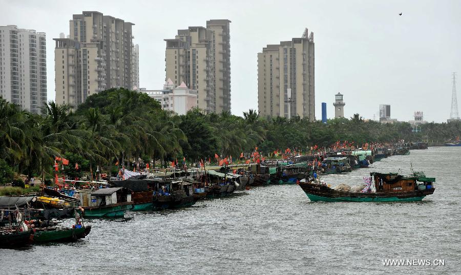 Fishing boats berth in a harbor in Haikou City, capital of south China's Hainan Province, June 22, 2013. Tropical storm "Bebinca" is estimated to arrive in south China's Guangdong Province on Saturday afternoon, the first to make landfall in China this year, the National Meteorological Center (NMC) said on Saturday. Affected by the tropical storm, coastal areas in Hainan and Guangdong provinces were battered by gales and torrential rain, the center reported. (Xinhua/Guo Cheng)