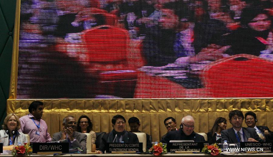 Delegates react after Hani Terraces was declared World Heritage Site during the 37th session of the World Heritage Committee in Phnom Penh, Cambodia, June 22, 2013. The UNESCO's World Heritage Committee inscribed China's cultural landscape of Honghe Hani Rice Terraces onto the prestigious World Heritage List on Saturday, bringing the total number of World Heritage Sites in China to 45. (Xinhua/Li Ying) 