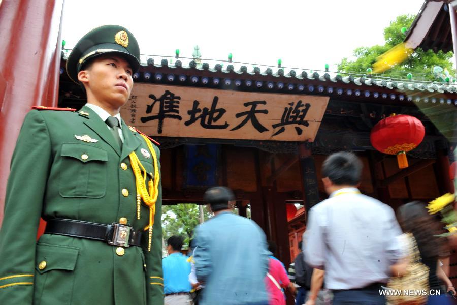 People attend a sacrifice ceremony at "the Temple of Fu Xi" in Tianshui, northwest China's Gansu Province, June 22, 2013. More than 20,000 Chinese from China and abroad attended a sacrifice ceremony held here Saturday to pay tribute to Fu Xi, a culture hero who is believed to be the inventor of writing, fishing and hunting. Fu Xi is regarded as one of the ancestors of the Chinese nation. (Xinhua/Chen Bin) 