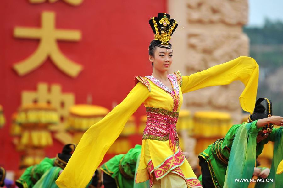 Dancers dressed in ancient costumes perform during a sacrifice ceremony at "the Temple of Fu Xi" in Tianshui, northwest China's Gansu Province, June 22, 2013. More than 20,000 Chinese from China and abroad attended a sacrifice ceremony held here Saturday to pay tribute to Fu Xi, a culture hero who is believed to be the inventor of writing, fishing and hunting. Fu Xi is regarded as one of the ancestors of the Chinese nation. (Xinhua/Chen Bin) 