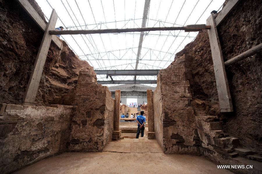 Photo taken on June 22, 2013 shows the archeological site of an ancient tomb in Fangshan District of Beijing, capital of China. A gravestone excavated from the tomb confirmed that the tomb was the final resting place of Liu Ji, a regional military governor of the Tang Dynasty (618-907), and his wife. Archaeologists have started a salvage excavation of the tumulus since August 2012, after it was accidentally discovered at a local construction site. Valuable cultural relics, including an exquisite stone coffin bed, were discovered. (Xinhua/Luo Xiaoguang) 
