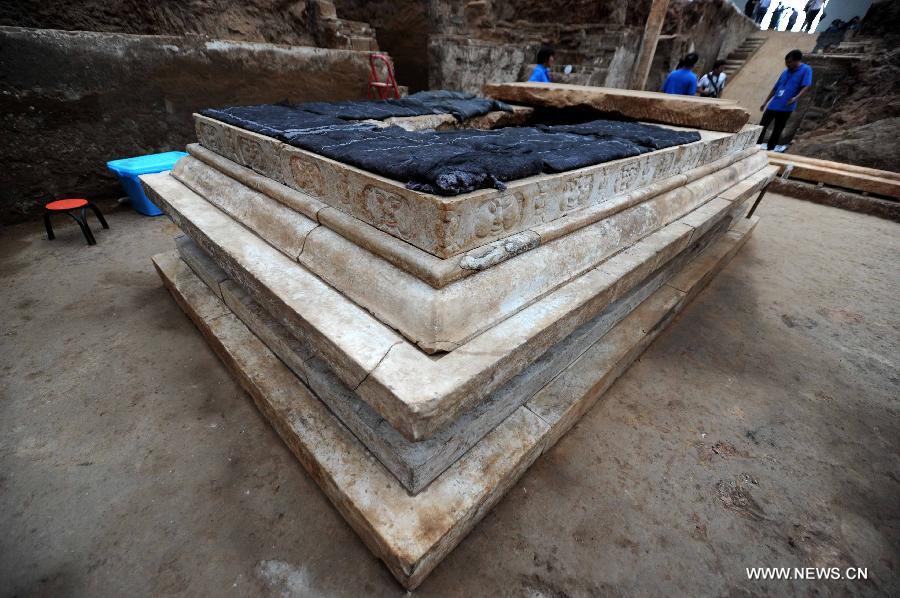 Photo taken on June 22, 2013 shows an exquisite stone coffin bed at the archeological site of an ancient tomb in Fangshan District of Beijing, capital of China. A gravestone excavated from the tomb confirmed that the tomb was the final resting place of Liu Ji, a regional military governor of the Tang Dynasty (618-907), and his wife. Archaeologists have started a salvage excavation of the tumulus since August 2012, after it was accidentally discovered at a local construction site. Valuable cultural relics, including an exquisite stone coffin bed, were discovered. (Xinhua/Luo Xiaoguang)