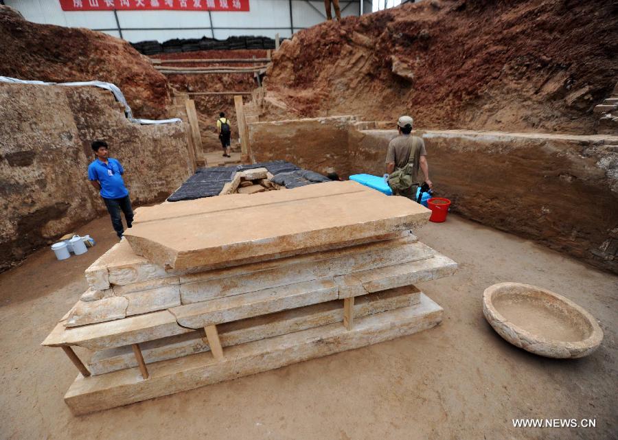 Photo taken on June 22, 2013 shows an exquisite stone coffin bed at the archeological site of an ancient tomb in Fangshan District of Beijing, capital of China. A gravestone excavated from the tomb confirmed that the tomb was the final resting place of Liu Ji, a regional military governor of the Tang Dynasty (618-907), and his wife. Archaeologists have started a salvage excavation of the tumulus since August 2012, after it was accidentally discovered at a local construction site. Valuable cultural relics, including an exquisite stone coffin bed, were discovered. (Xinhua/Luo Xiaoguang)