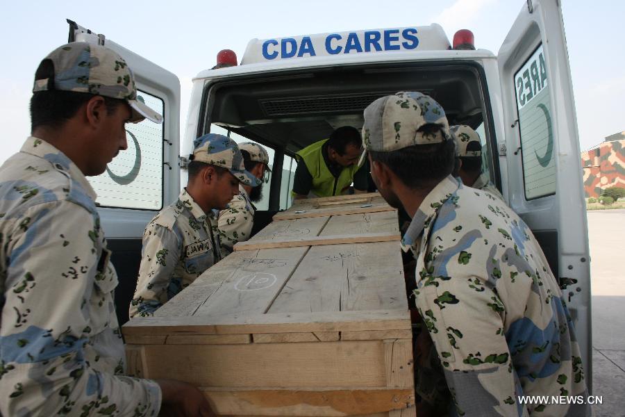 A coffin of a Chinese victim was taken into a car in Islamabad, Pakistan, June 23, 2013. Two Chinese nationals and one Chinese American were among the 11 people killed in a pre-dawn terrorist attack in Pakistan's northern area of Gilgit-Baltistan on Sunday, the Chinese Embassy in Pakistan told Xinhua. (Xinhua/Zhang Yong) 