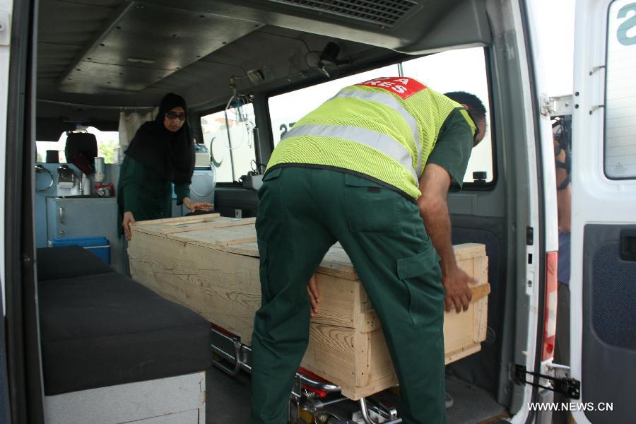 A coffin of a Chinese victim was taken into a car in Islamabad, Pakistan, June 23, 2013. Two Chinese nationals and one Chinese American were among the 11 people killed in a pre-dawn terrorist attack in Pakistan's northern area of Gilgit-Baltistan on Sunday, the Chinese Embassy in Pakistan told Xinhua. (Xinhua/Zhang Yong)