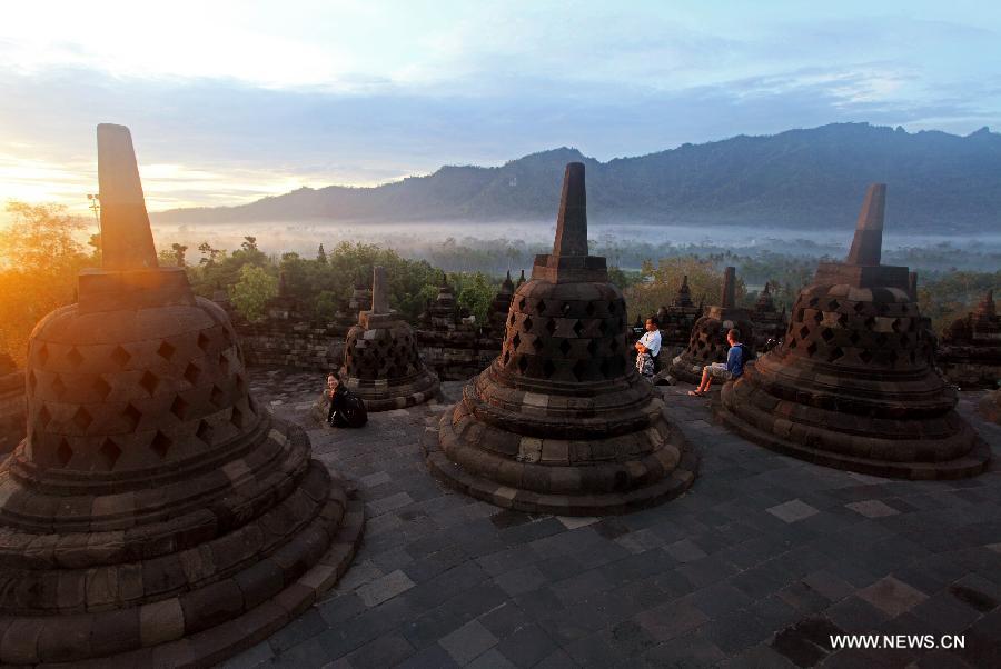The photo taken on Dec. 20, 2012 shows the Borobudur stupas during sunrise in Central Java, Indonesia. Borobudur is a 9th-century Mahayana Buddhist Temple. It was listed as a UNESCO World Heritage Site in 1991 and confirmed as the largest temple in the world by the Guiness World Records in 2012. (Xinhua/Jiang Fan) 