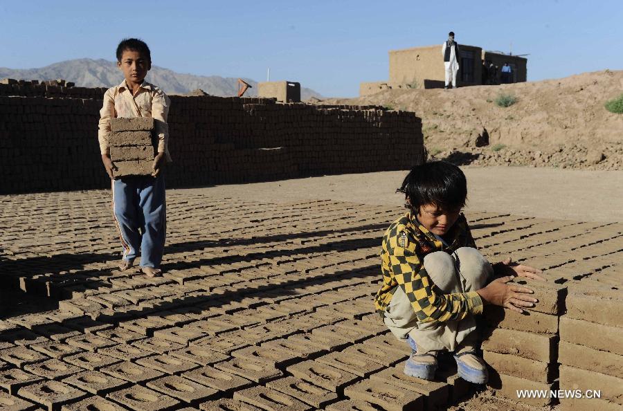 Two Afghan brothers work at a brick factory in Herat province, western Afghanistan on June 17, 2013. (Xinhua/Sardar) 