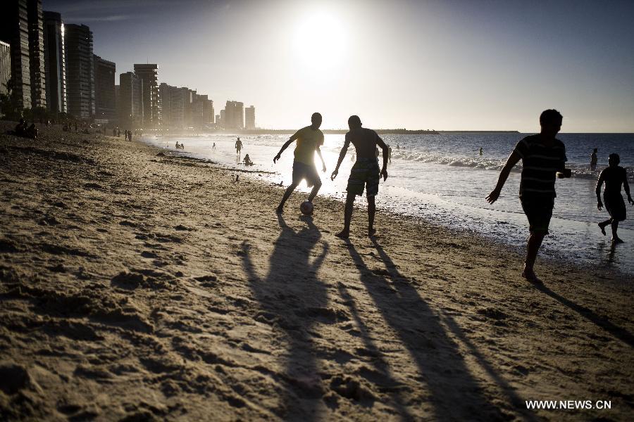Residents play soccer on Iracema Beach, in Fortaleza, Ceara state, Brazil, on June 16, 2013. The FIFA Confederations Cup Brazil 2013 began on June 15. (Xinhua/Guillermo Arias)