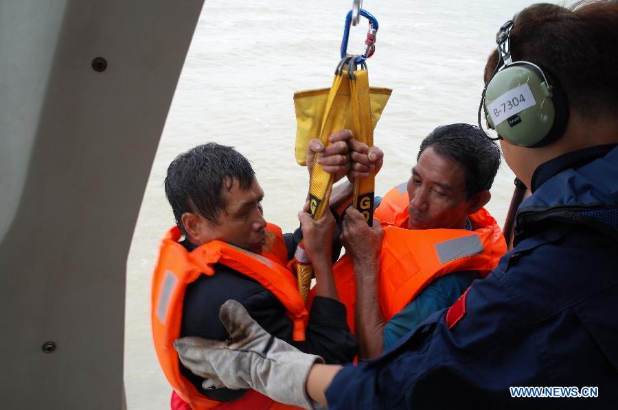 Seamen on a wrecked freighter are hoisted to a helicopter at the sea near Basuo Port in Dongfang, southernmost China's Hainan Province, June 23, 2013. Feignters "Changxinshun 888" and "Jinma 788" capsized due to the arrival of tropical storm Bebinca near Basuo Port Sunday. All the 12 crew members were saved by local maritime safety administration and the First Rescue Squadron of the South China Sea. (Xinhua) 