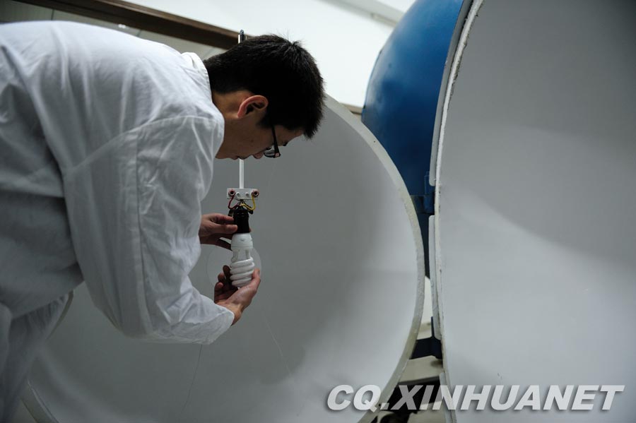 Laboratory staff measures the lighting intensity. (Xinhua/ Huang Junhui) 