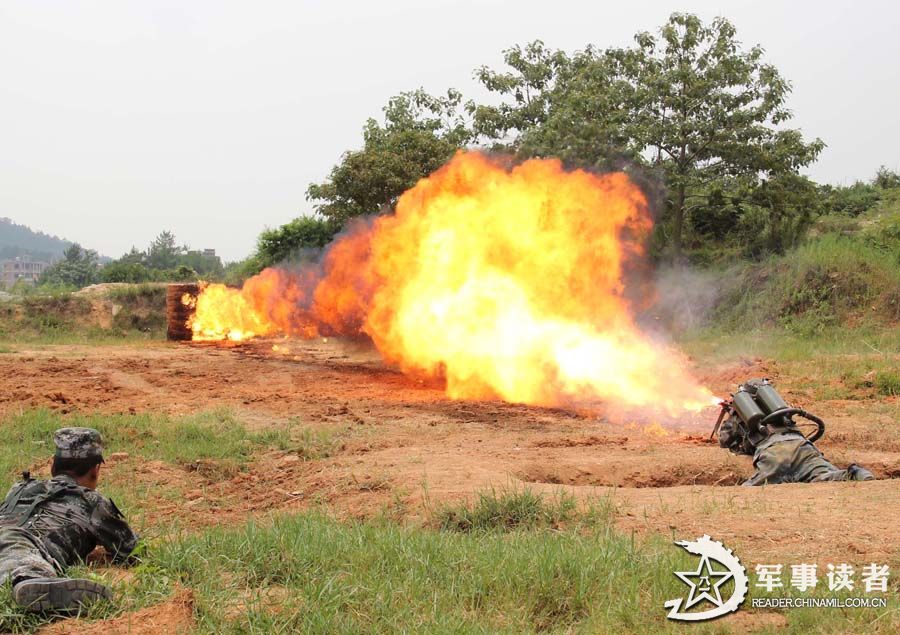 A brigade under the Nanjing Military Area Command (MAC) of the Chinese People's Liberation Army conducted anti-chemical drill from June 9 to June 11, 2013, so as to improve the actual-combat capability of its officers and men. The photo shows that a soldier fires with a flame projector. (Chinamil.com.cn/Yu Jinhu and Mao Heping)