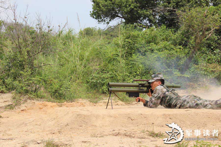 A brigade under the Nanjing Military Area Command (MAC) of the Chinese People's Liberation Army conducted anti-chemical drill from June 9 to June 11, 2013, so as to improve the actual-combat capability of its troops. The photo shows that a soldier is firing with a bazooka. (Chinamil.com.cn/Yu Jinhu and Mao Heping)