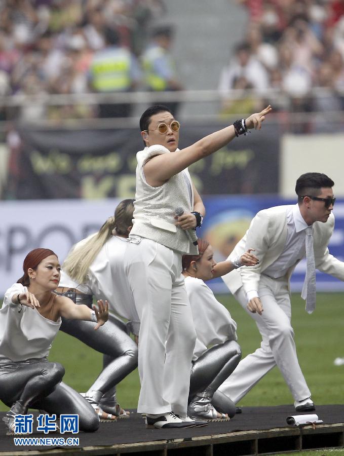South Korean singer Psy performs during a charity soccer match between the Park Ji-sung and Friends team and Shanghai Laokele Stars at the Shanghai Hongkou Stadium in Shanghai, June 23, 2013.(Photo/Xinhua)