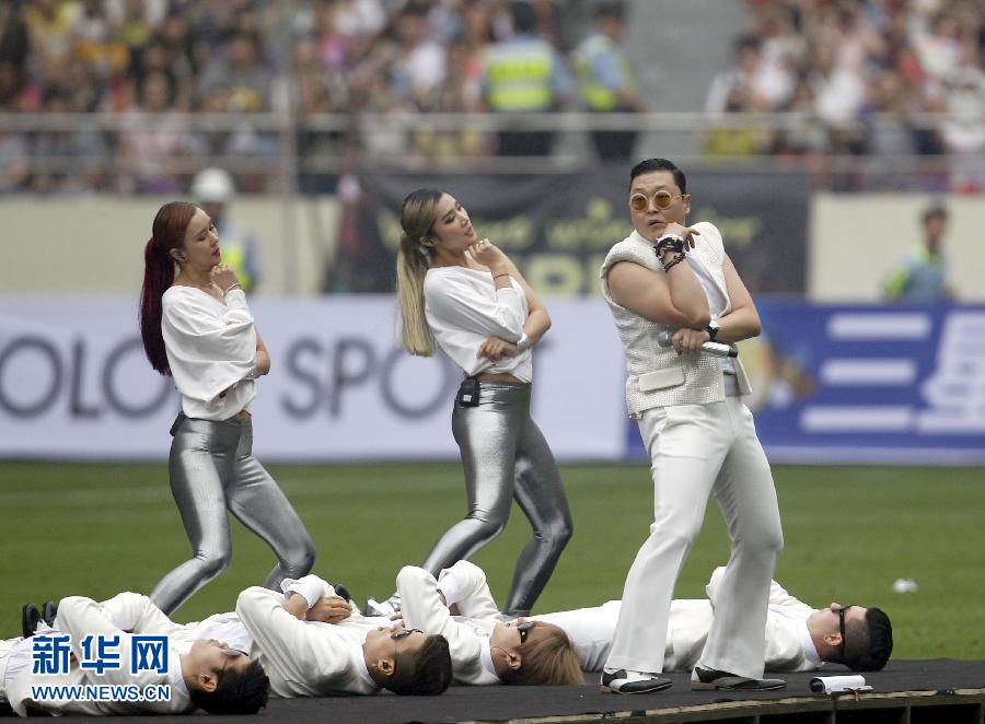 South Korean singer Psy performs during a charity soccer match between the Park Ji-sung and Friends team and Shanghai Laokele Stars at the Shanghai Hongkou Stadium in Shanghai, June 23, 2013. (Photo/Xinhua)