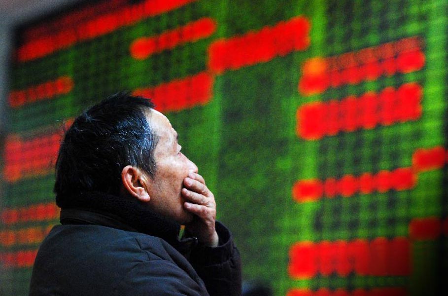 A stock investor looks at the electric board showing stock prices in a trading hall of a securities firm in Hangzhou on Jan. 10, 2012. Chinese shares soared on that day. The benchmark Shanghai Composite Index rose 2.69 percent to close at 2,285.74 points; The Shenzhen Component Index closed at 9,281.5 points, up 3.75 percent. (Xinhua/ Han Chuanhao) 