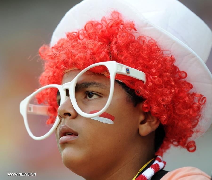 A fan of Tahiti reacts prior the FIFA's Confederations Cup Brazil 2013 match against Uruguay, held at Arena Pernambuco Stadium, in Recife, Pernambuco state, Brazil, on June 23, 2013. (Xinhua/Weng Xinyang)