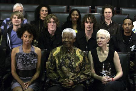 Former South African President Nelson Mandela (C) smiles at the Gallagher Estate during a news conference Nov. 30, 2007, with some of the musicians who will take part in the upcoming 46664 AIDS charity concert at Ellispark stadium. The concert, which will coincide with World AIDS Day on December 1, is an offshoot of similar shows that have been held in South Africa, Spain and Norway. (Xinhua/Reuters Photo)