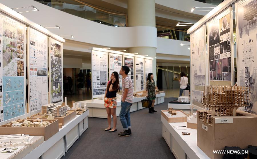 Visitors look at the artworks presented in the 17th Graduation Show "Interlude" organized by the School of Architecture of the Chinese University of Hong Kong (CUHK) in Hong Kong, south China, June 24, 2013. The show will last till June 30. (Xinhua/Li Peng) 