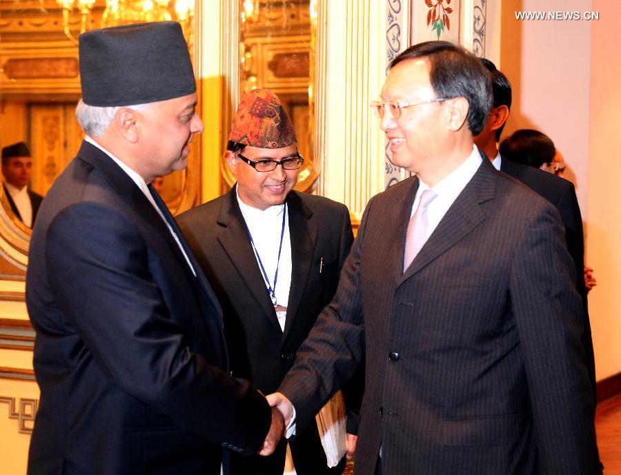 Chinese State Councilor Yang Jiechi (front, R) shakes hands with Nepali Foreign Minister Madhav Ghimire (front, L) during a meeting in Kathmandu, capital of Nepal, June 24, 2013. (Xinhua/Zhou Shengping)