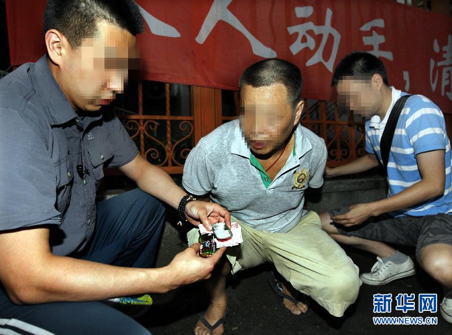A suspect drug dealer is caught in Shanghai, June 24, 2013. (Photo/Xinhua)