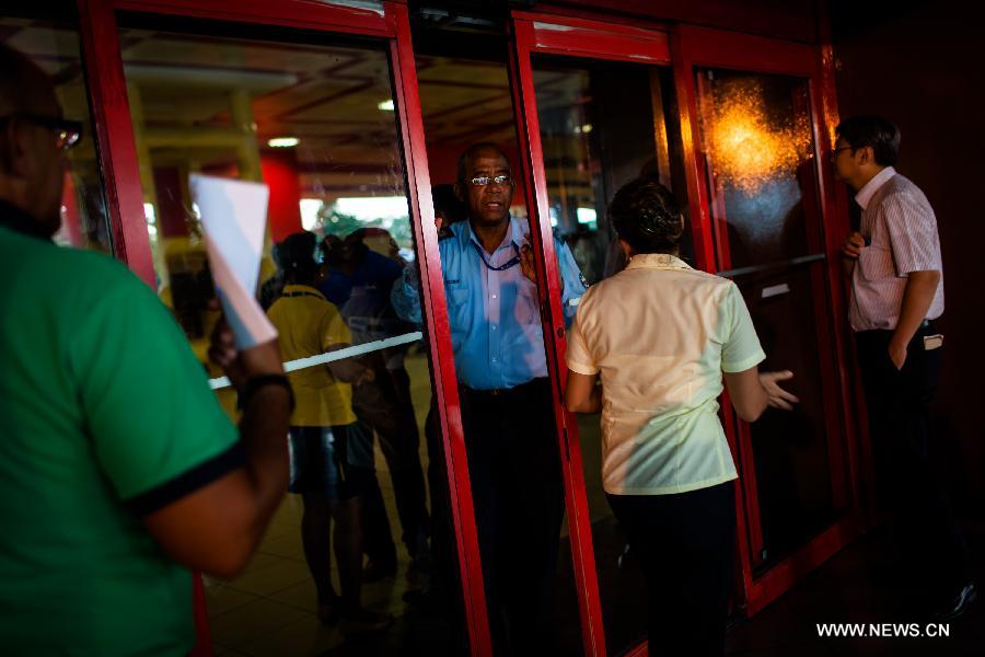 A staff closes an exit to the flight SU150 from Moscow, Russia, due to the emergency of too many journalists at the Jose Marti airport in Havana, Cuba, June 24, 2013. Former U.S. intelligence contractor Edward Snowden did not show up at the flight. (Xinhua/Liu Bin) 