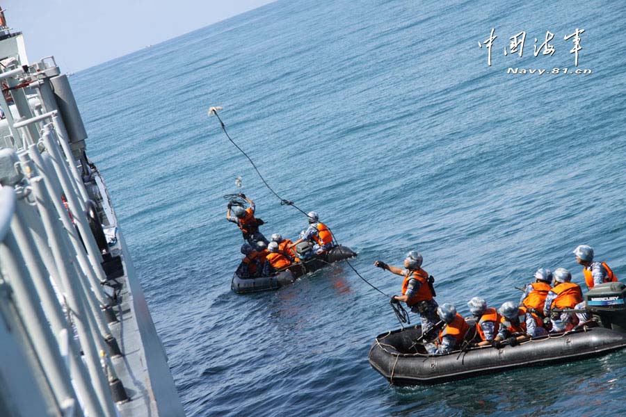 A special operation detachment under a marine brigade of the Chinese People's Liberation Army Navy (PLAN) conducts a joint escorting training with a landing ship flotilla of the PLAN on the high-risk subjects, such as climbing boarding, cabin search, sea blockade and arresting pirates. (China Military Online/ Sun Haichao and Jiang Zhengyuan)