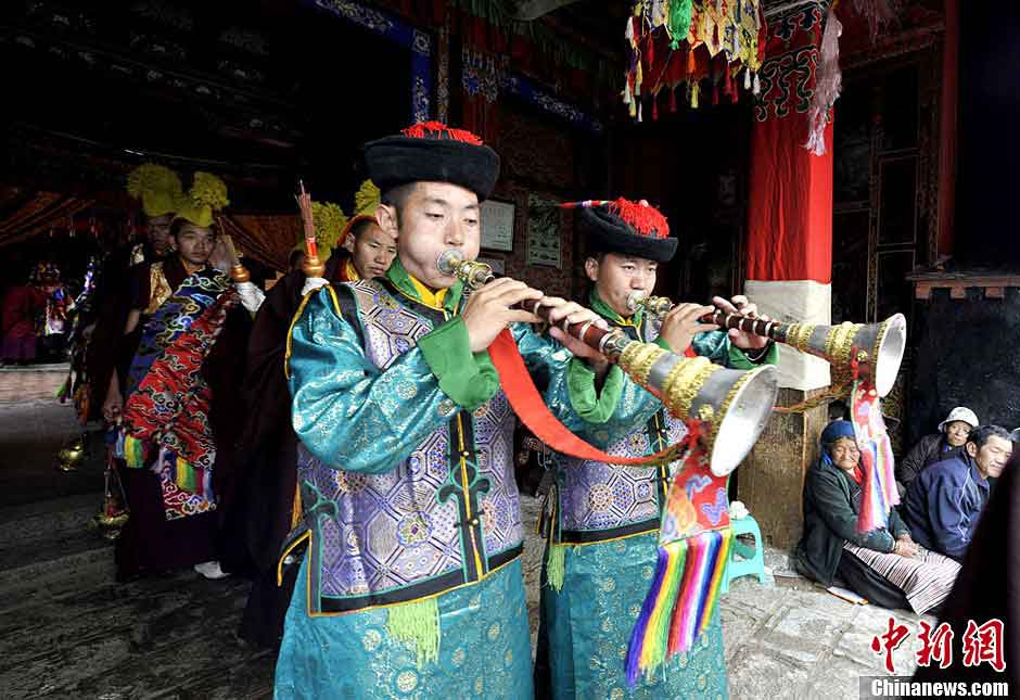 Lamas prepare for "Qiang Mu" dance in Samye Monastery in Chanang County, Southwest China's Tibet Autonomous Region, June 24, 2013. "Qiang Mu," a religious dance of Tibetan Buddhism, is a well-established performing art form combining scripture chanting in perfect unison with music and dance, and performed in temples by lamas with solemn and splendid atmospheres. (CNS/Li Lin)