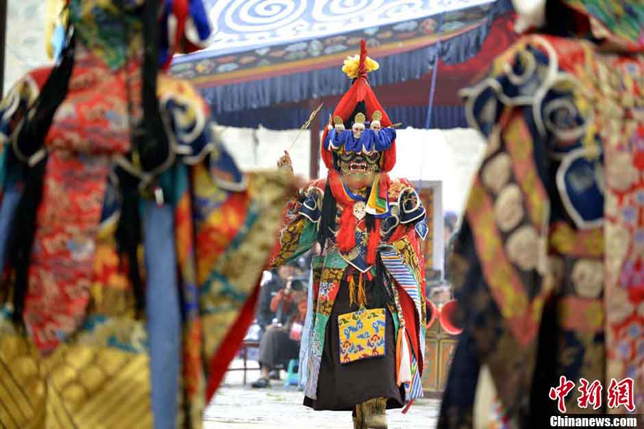 Lamas wearing masks perform "Qiang Mu" dance in Samye Monastery in Chanang County, Southwest China's Tibet Autonomous Region, June 24, 2013. "Qiang Mu," a religious dance of Tibetan Buddhism, is a well-established performing art form combining scripture chanting in perfect unison with music and dance, and performed in temples by lamas with solemn and splendid atmospheres. (CNS/Li Lin)