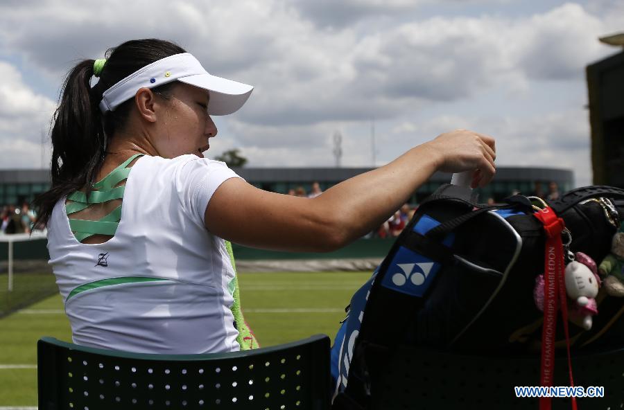 Zheng Jie of China packs her racket after the first round of ladies' singles against Caroline Garcia of France on day 2 of the Wimbledon Lawn Tennis Championships at the All England Lawn Tennis and Croquet Club in London, Britain on June 25, 2013. Zheng lost 0-2. (Xinhua/Wang Lili)
