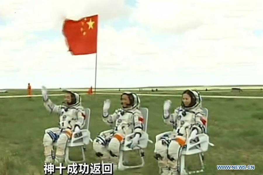 The screenshot shows astronauts Zhang Xiaoguang, Nie Haisheng and Wang Yaping (from left to right) waving to people after going out of the re-entry capsule of China's Shenzhou-10 spacecraft following its successful landing at the main landing site in north China's Inner Mongolia Autonomous Region on June 26, 2013. (Xinhua)
