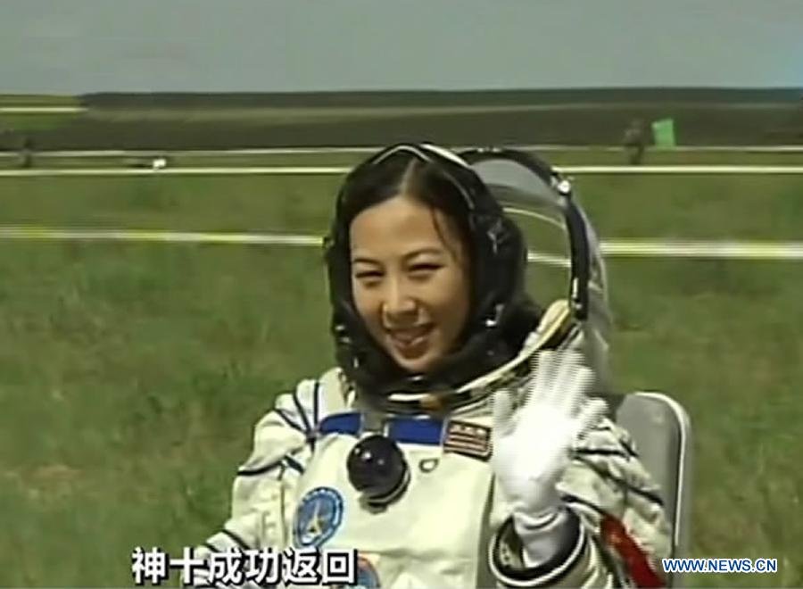 The screenshot shows astronaut Wang Yaping waving to people after going out of the re-entry capsule of China's Shenzhou-10 spacecraft following its successful landing at the main landing site in north China's Inner Mongolia Autonomous Region on June 26, 2013. (Xinhua) 