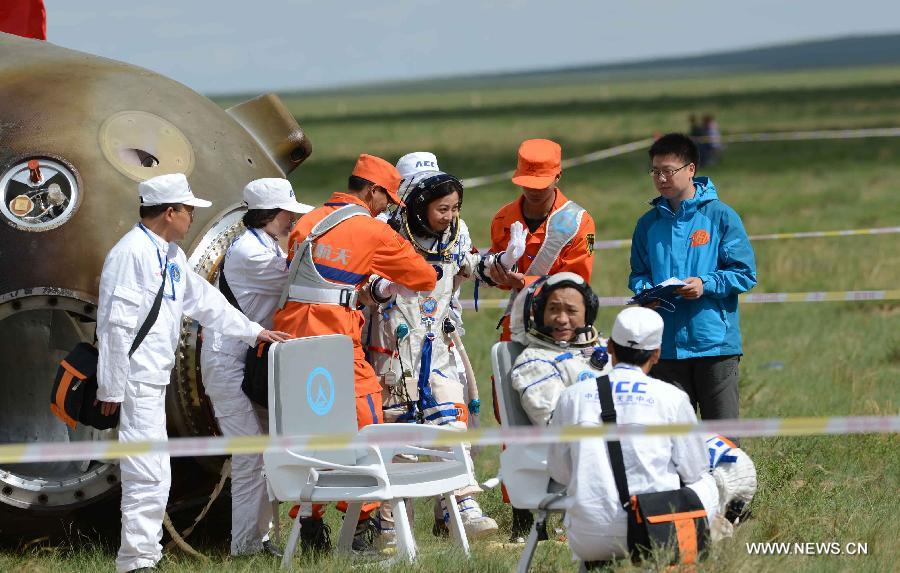 Astronaut Wang Yaping goes out of the re-entry capsule of China's Shenzhou-10 spacecraft following its successful landing at the main landing site in north China's Inner Mongolia Autonomous Region on June 26, 2013. (Xinhua/Zhang Ling)