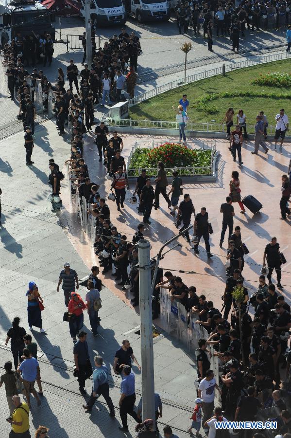 Riot police seal off the Taksim Square in Istanbul on June 25, 2013. Over 5,000 Turks staged a demonstration in Istanbul's iconic Taksim Square Tuesday to denounce the release of a police officer suspected of killing a protestor in Ankara. (Xinhua/Lu Zhe)