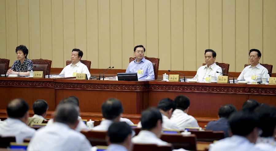 Zhang Dejiang (C back), chairman of China's National People's Congress (NPC) Standing Committee, presides over the first plenary meeting of the third session of the 12th NPC Standing Committee in Beijing, capital of China, June 26, 2013 (Xinhua/Zhang Duo) 