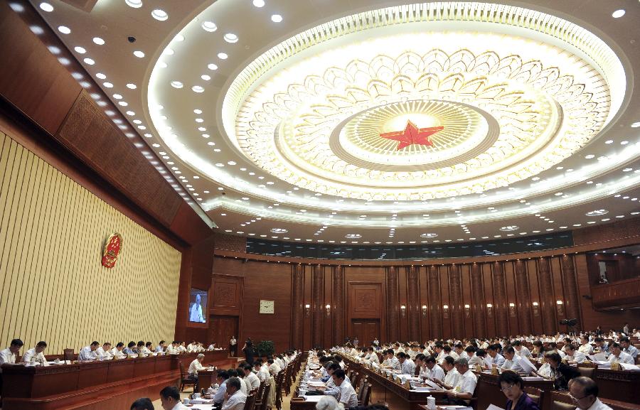 The first plenary meeting of the third session of China's 12th National People's Congress (NPC) Standing Committee is held in Beijing, capital of China, June 26, 2013. Zhang Dejiang, chairman of the NPC Standing Committee, presides over the meeting. (Xinhua/Zhang Duo) 