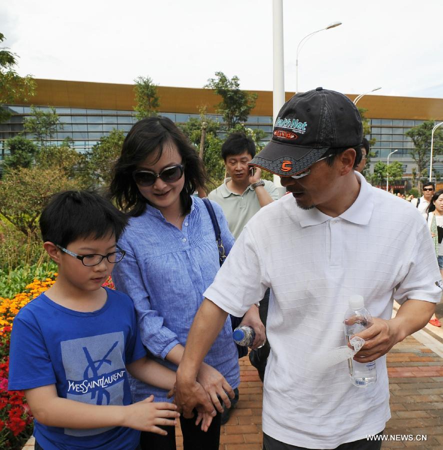 Survivor of a terror attack Zhang Jingchuan (R, front) walks with his family after arriving at the airport in Kunming, capital of southwest China's Yunnan Province, June 26, 2013. Two Chinese mountaineers were among the victims killed in a pre-dawn terror attack in Pakistan-administered Kashmir on June 23. (Xinhua/Qin Lang) 