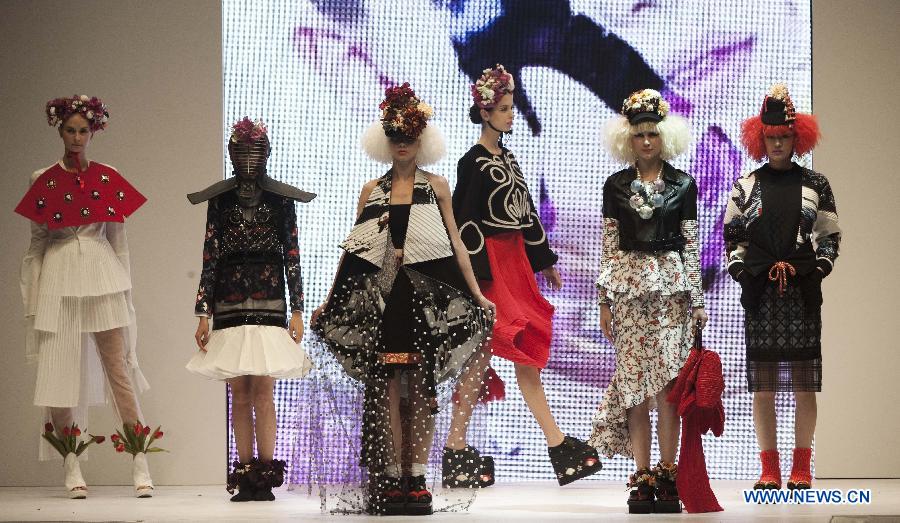 Models present creations by graduates from the Institute of Textiles and Clothing in Hong Kong Polytechnic University during their graduation show in Hong Kong, south China, June 26, 2013. (Xinhua/Lui Siu Wai)