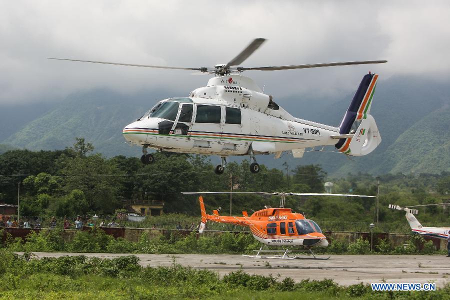 A helicopter takes off from the airport in Dehradun, northern Indian state of Uttarakhand, June 26, 2013. There are still an estimated 7000 people stranded in the flood while authorities use military planes and helicopters in the rescue in flood-ravaged northern India. (Xinhua/Zheng Huansong) 